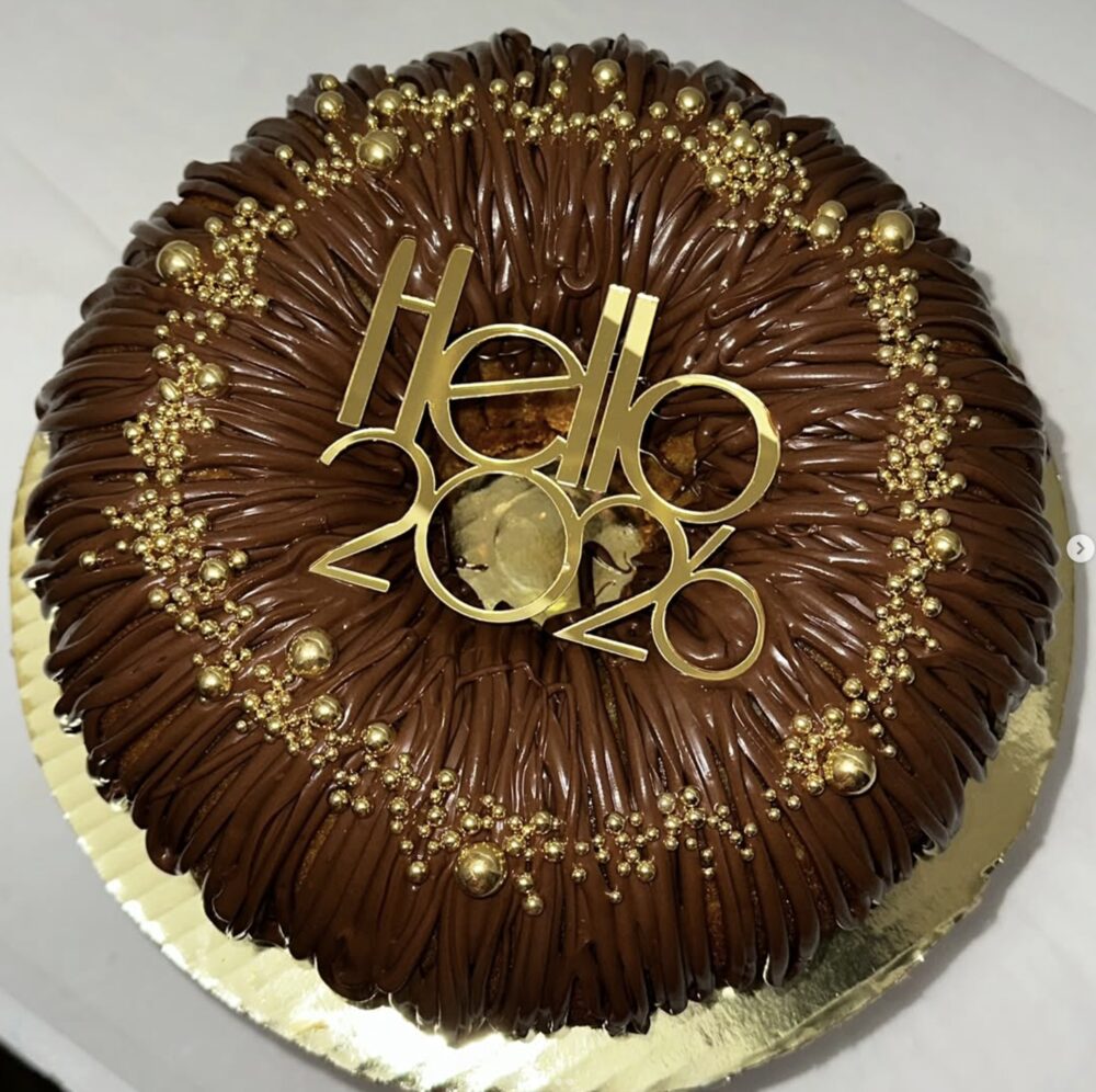 Round chocolate drip cake with gold 'Hello 2026' topper for New Year