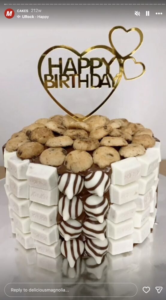 Chocolate drip birthday cake trimmed with Kit Kat bars and topped with mini cookies